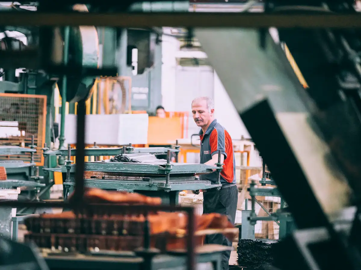 A machine operator running industrial production equipment